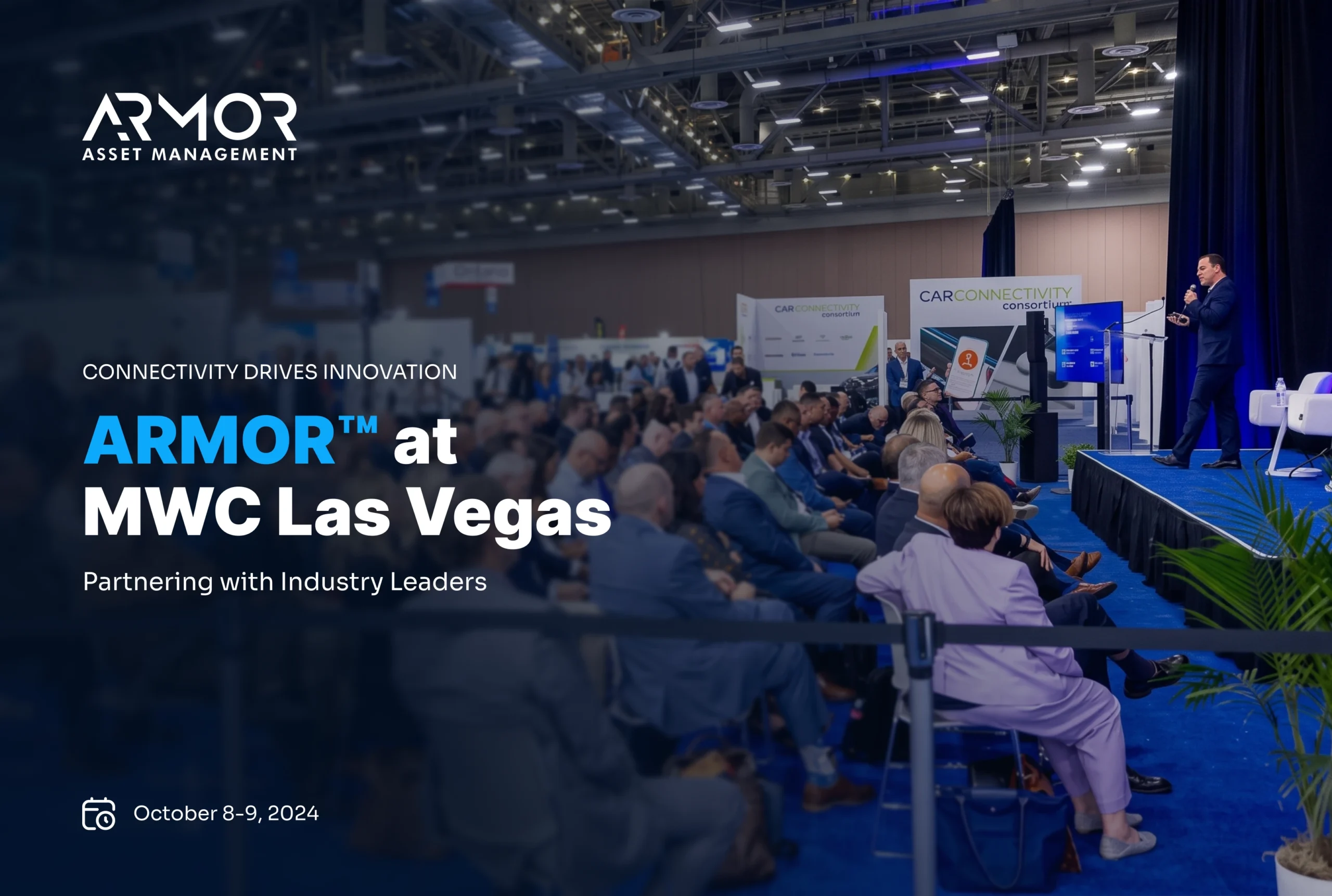 Armor™ Asset Management presentation at MWC Las Vegas convention hall with a speaker on stage and seated audience.