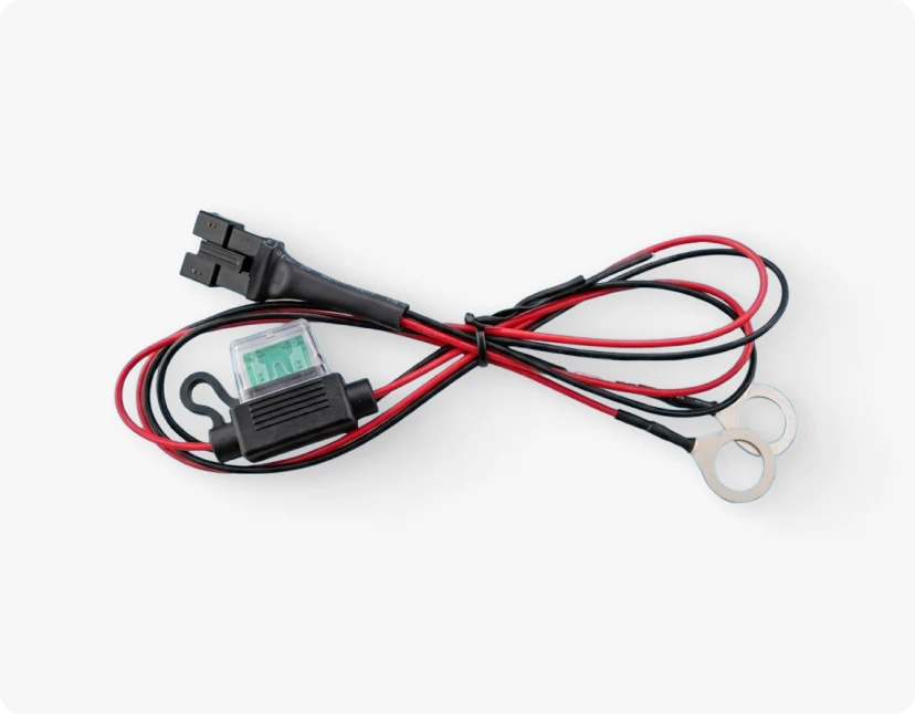 ARMOR™ A black and red cable with a small black and green device at the end