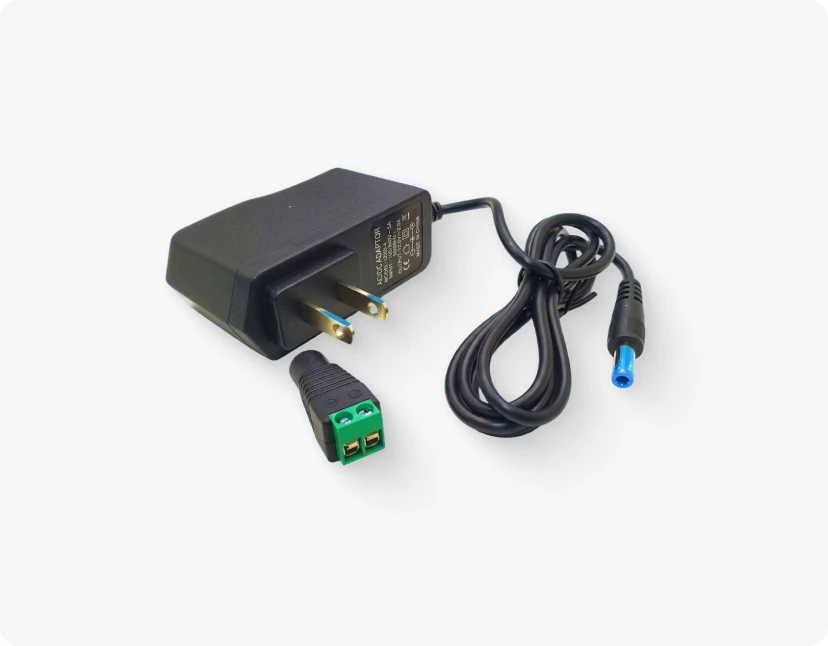 A black power adapter with a USB-C cable and a green USB-C adapter, both connected to a black power adapter with a label