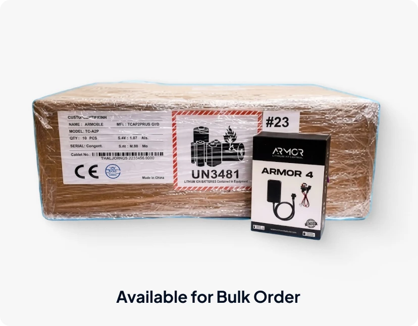 Bulk shrink-wrapped shipping box labeled with UN3481 lithium-ion battery warning, displayed next to an ARMOR 4™ product box, labeled "Available for Bulk Order".