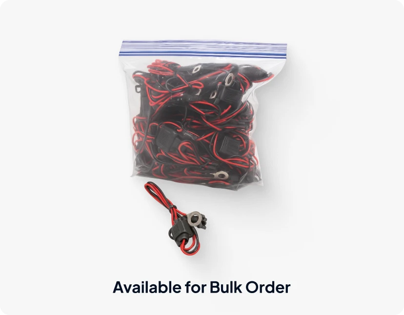 A plastic bag of red and black cable ties, with a single cable tie on the bottom, both with the ARMOR Asset Central™ logo