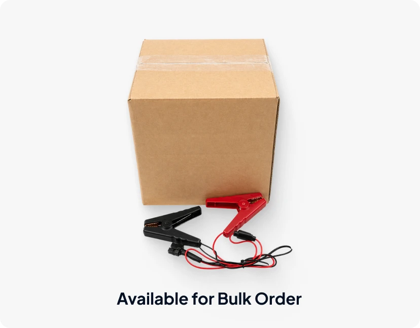 Bulk cardboard shipping box displayed with a pair of red and black alligator clip battery connectors in front, labeled "Available for Bulk Order".