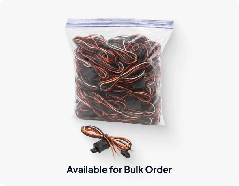 ARMOR™ A plastic bag filled with a tangled mess of black, red, and white wires, with a small black and red cable tied with a