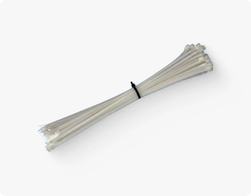 Bundle of white nylon cable ties secured with a small black tie wrap against a white background.